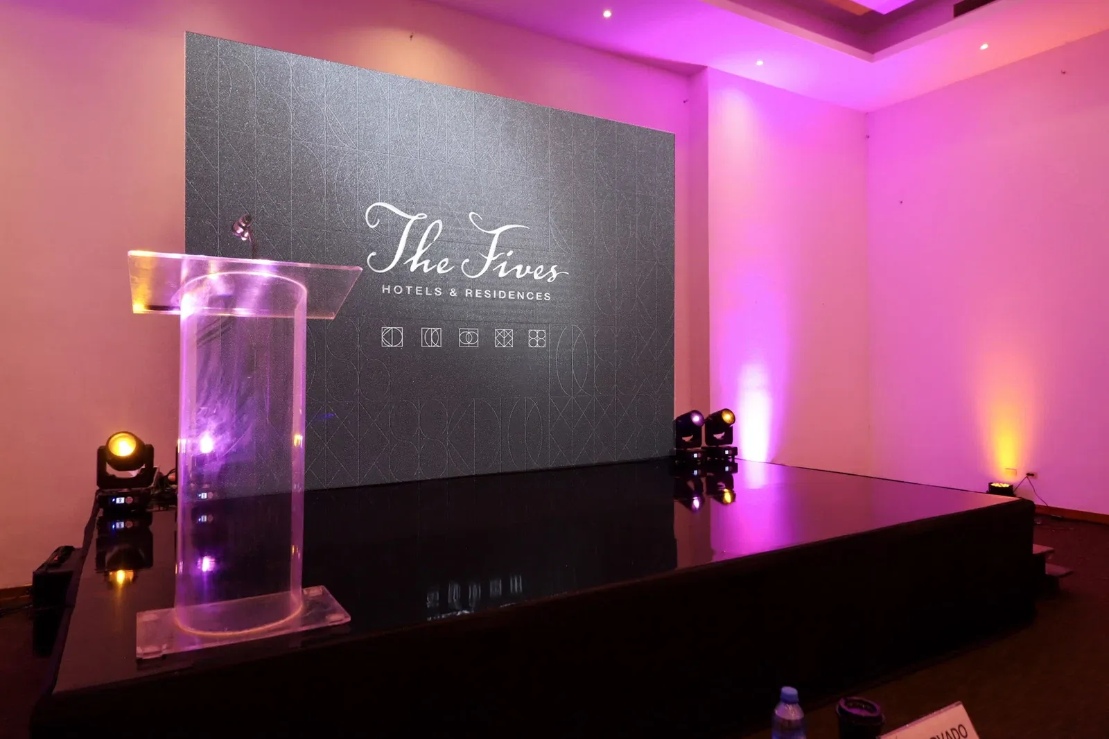 The Fives Hotels & Residences stage with podium and lighting. The Fives Corpo