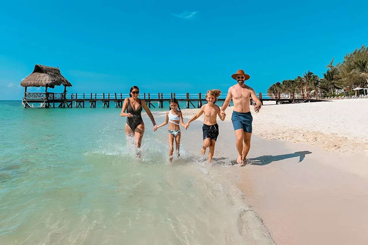 Family runs into the ocean at The Fives Hotels & Residences, Mexico.