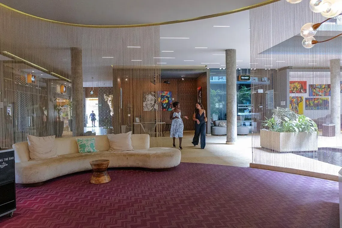 The Fives Downtown Hotel lobby: modern design with plush seating and art.