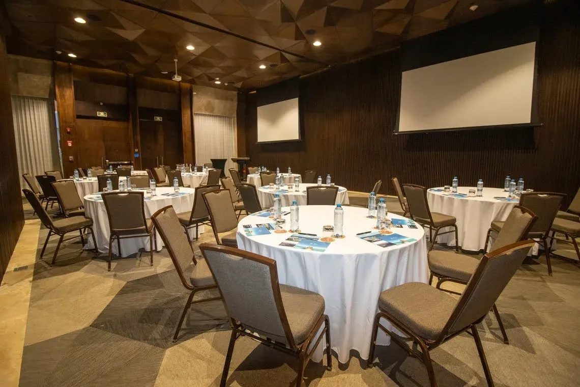Organized event setup with round tables and chairs at The Fives Downtown Hotel & Residences.