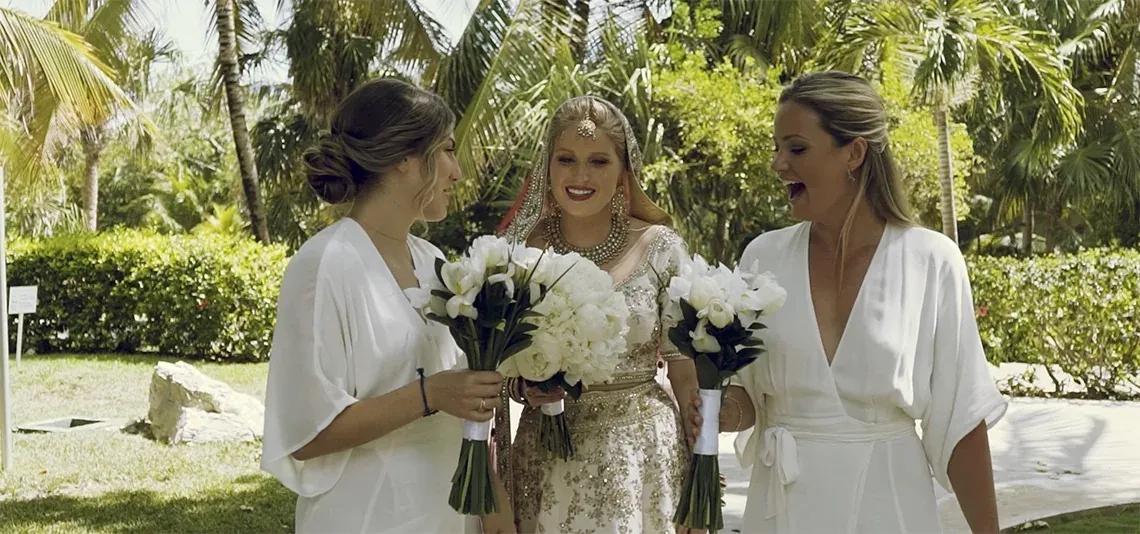 Brides at The Fives Dorado holding white bouquets.