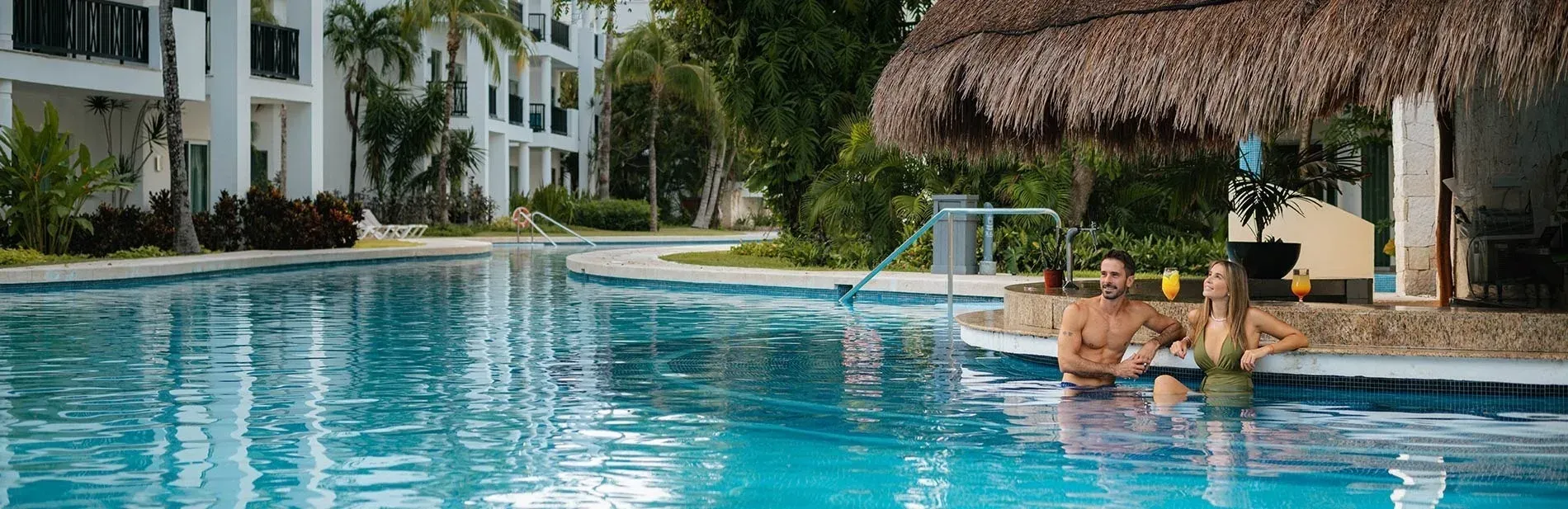 Couple enjoys poolside drinks at The Fives Hotels. Sense of joy!