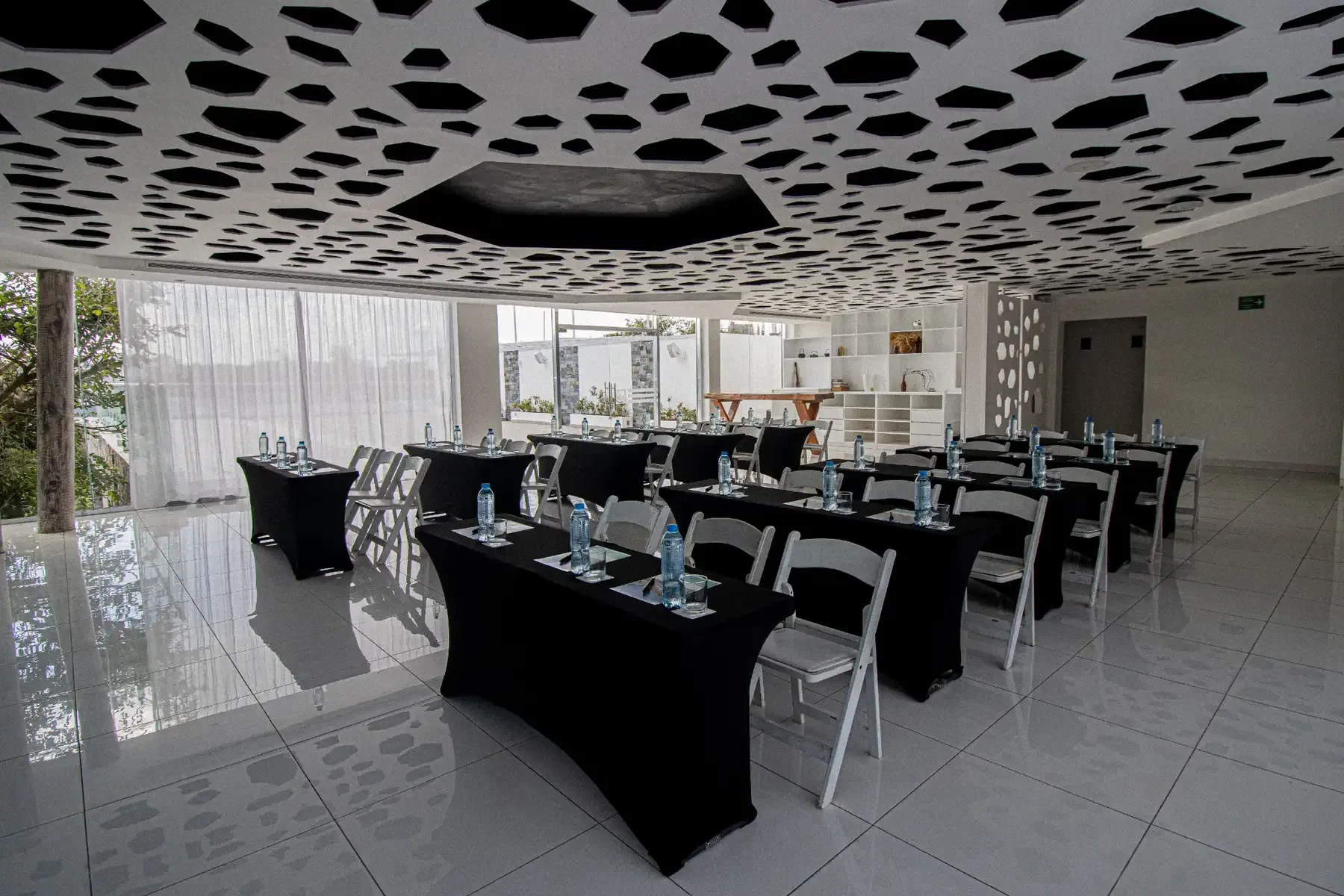 Modern conference room setup with black-draped tables and white chairs, perfect for The Fives Corpo events.