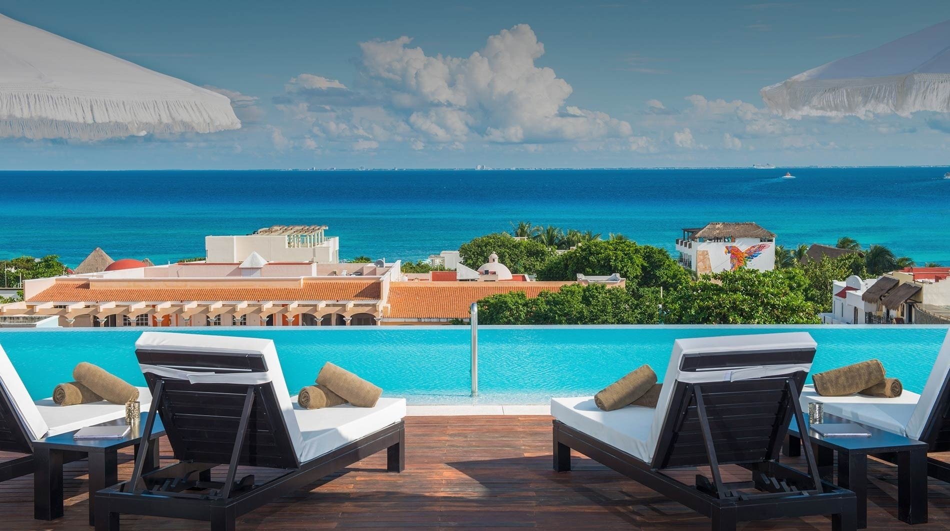 a large swimming pool with a view of the ocean