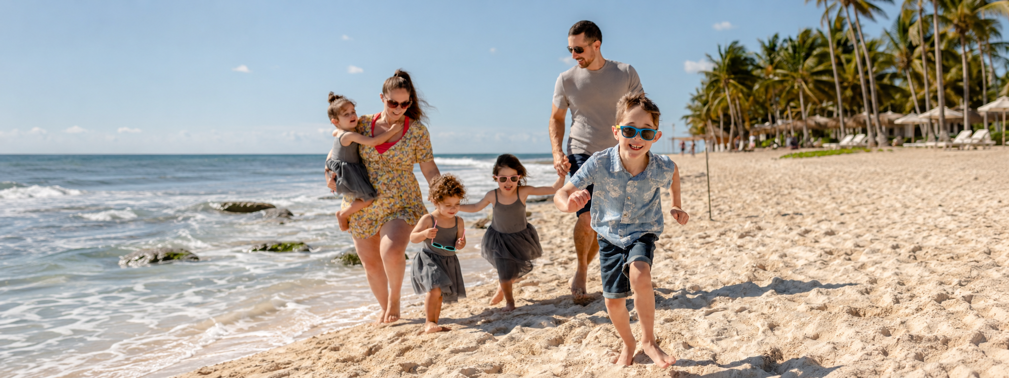 Family having fun on the beach. Family-friendly Resort in Riviera Maya.