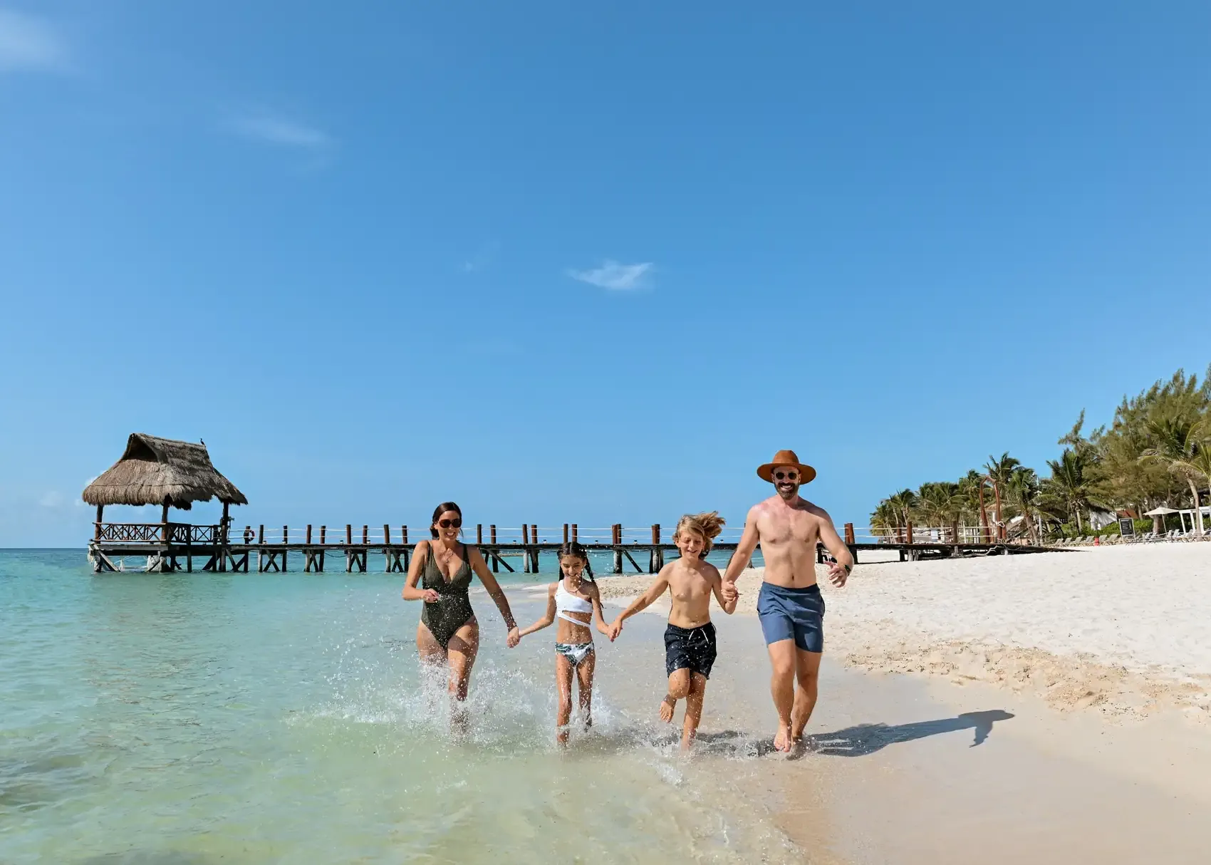 Family enjoying the beach at a Riviera Maya family resort