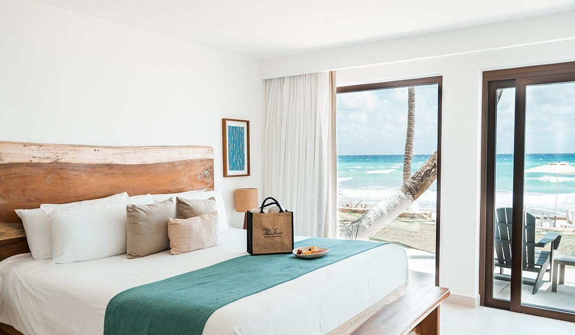 Luxury beachfront room at The Beachfront by The Fives, overlooking the Caribbean Sea.