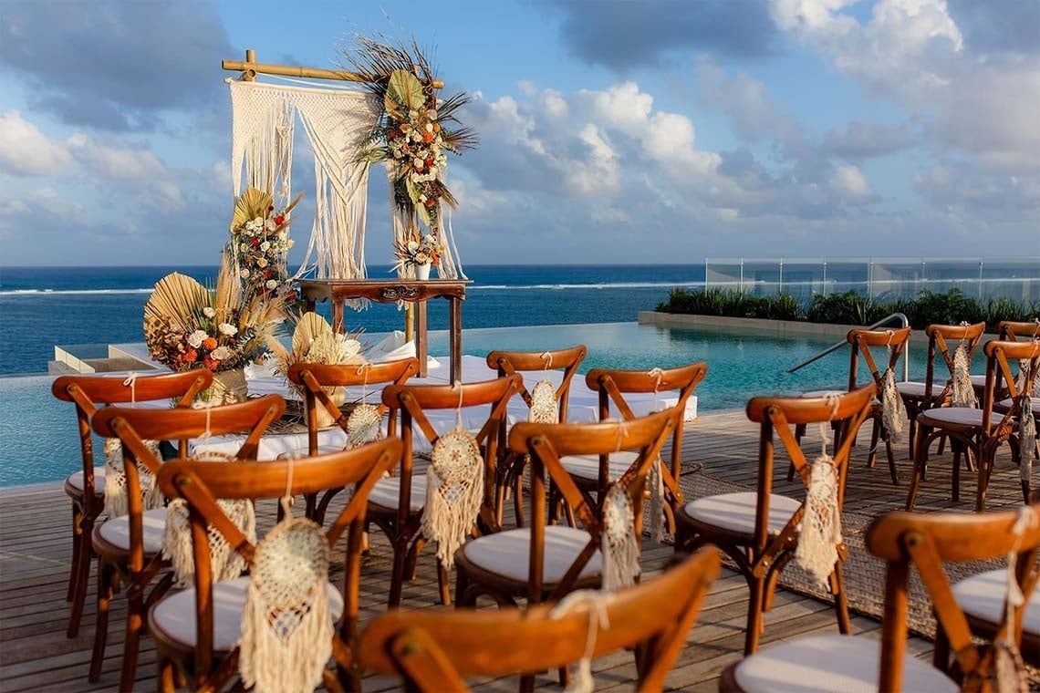 Oceanfront Wedding Packages: Beautiful boho ceremony setup with chairs overlooking the sea. The Fives Hotels.