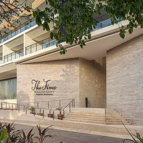 a building with a sign that says the fins oceanfront