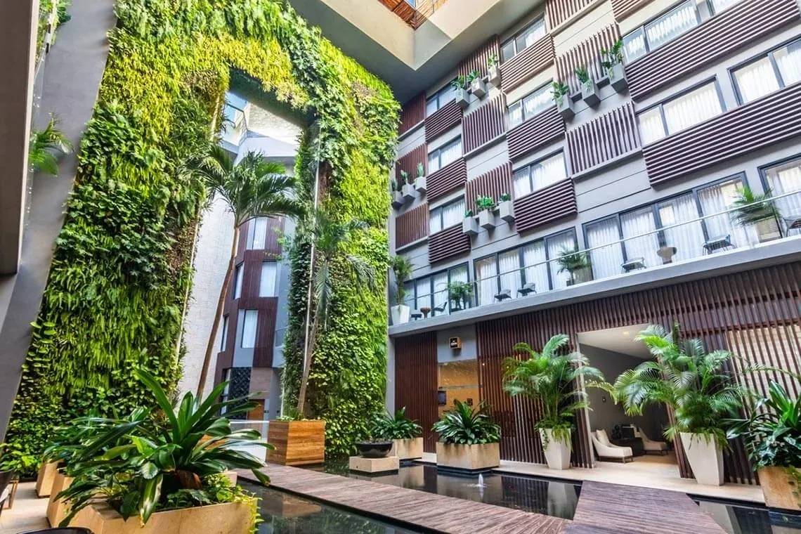 The Fives Downtown Hotel: Lush vertical gardens, modern architecture, pool at The Fives Downtown Hotel - Curio Collection by Hilton.