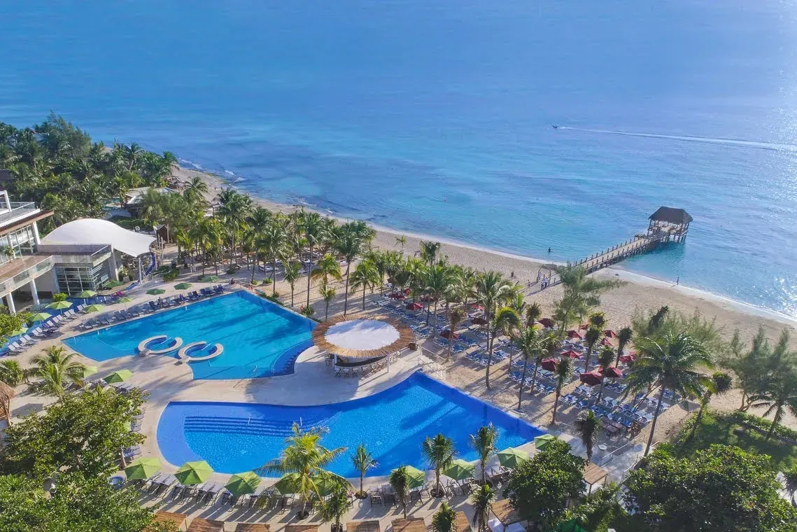The Fives Corpo: Luxury resort with pools, beach, and pier.