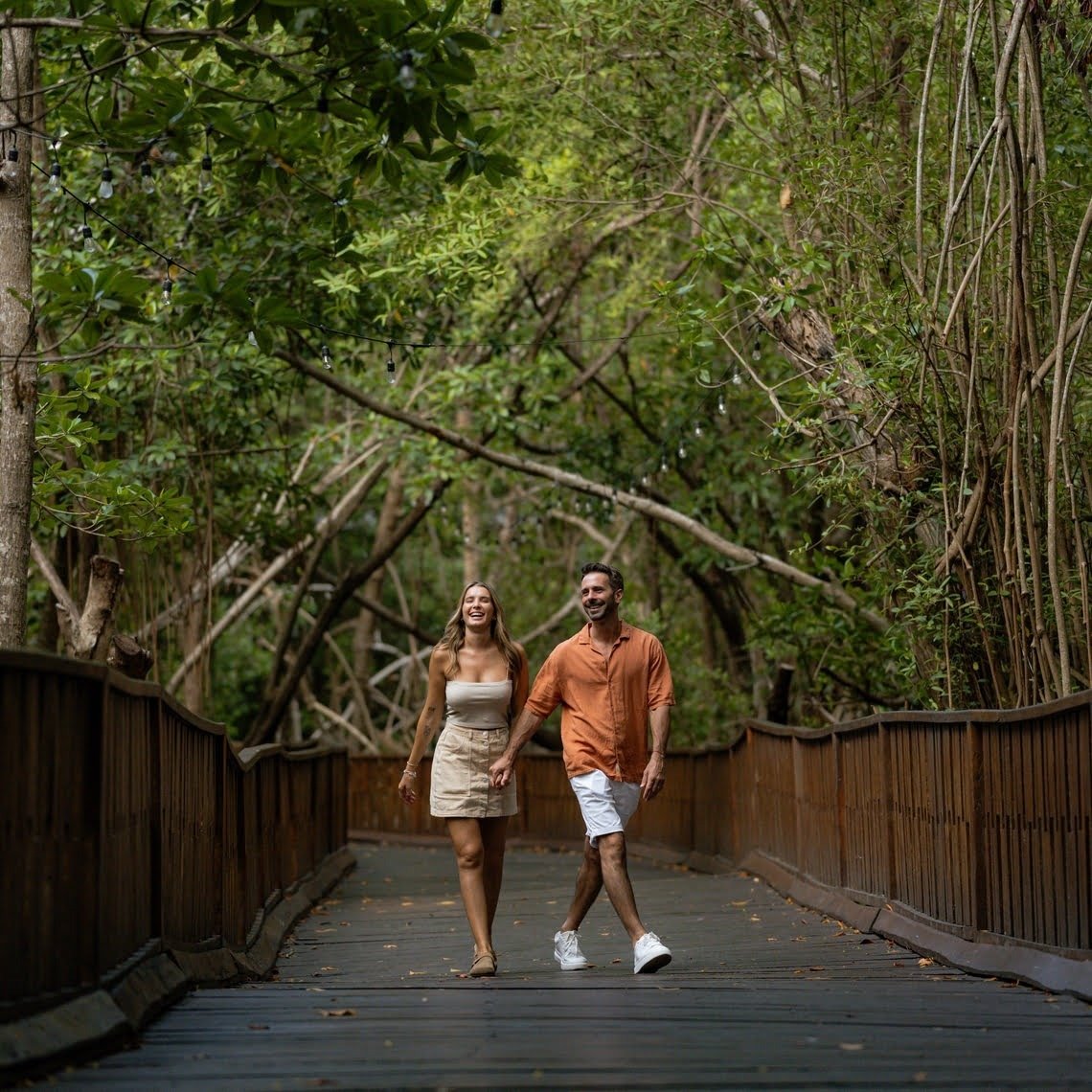 a woman in a green dress is walking with her daughter