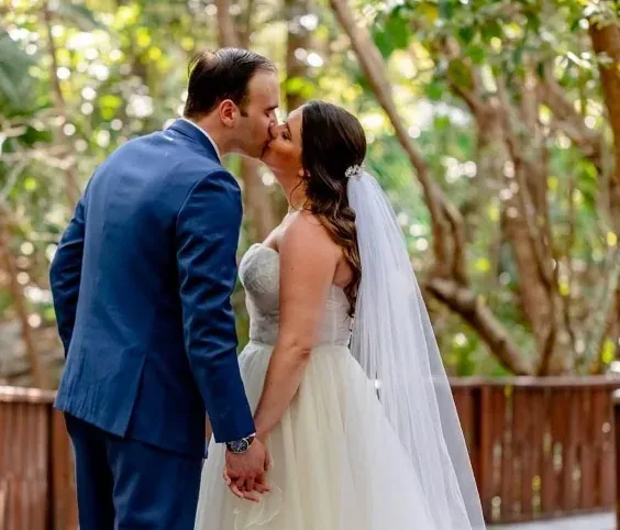 Newlyweds share a kiss at The Fives Corpo, an idyllic wedding venue.