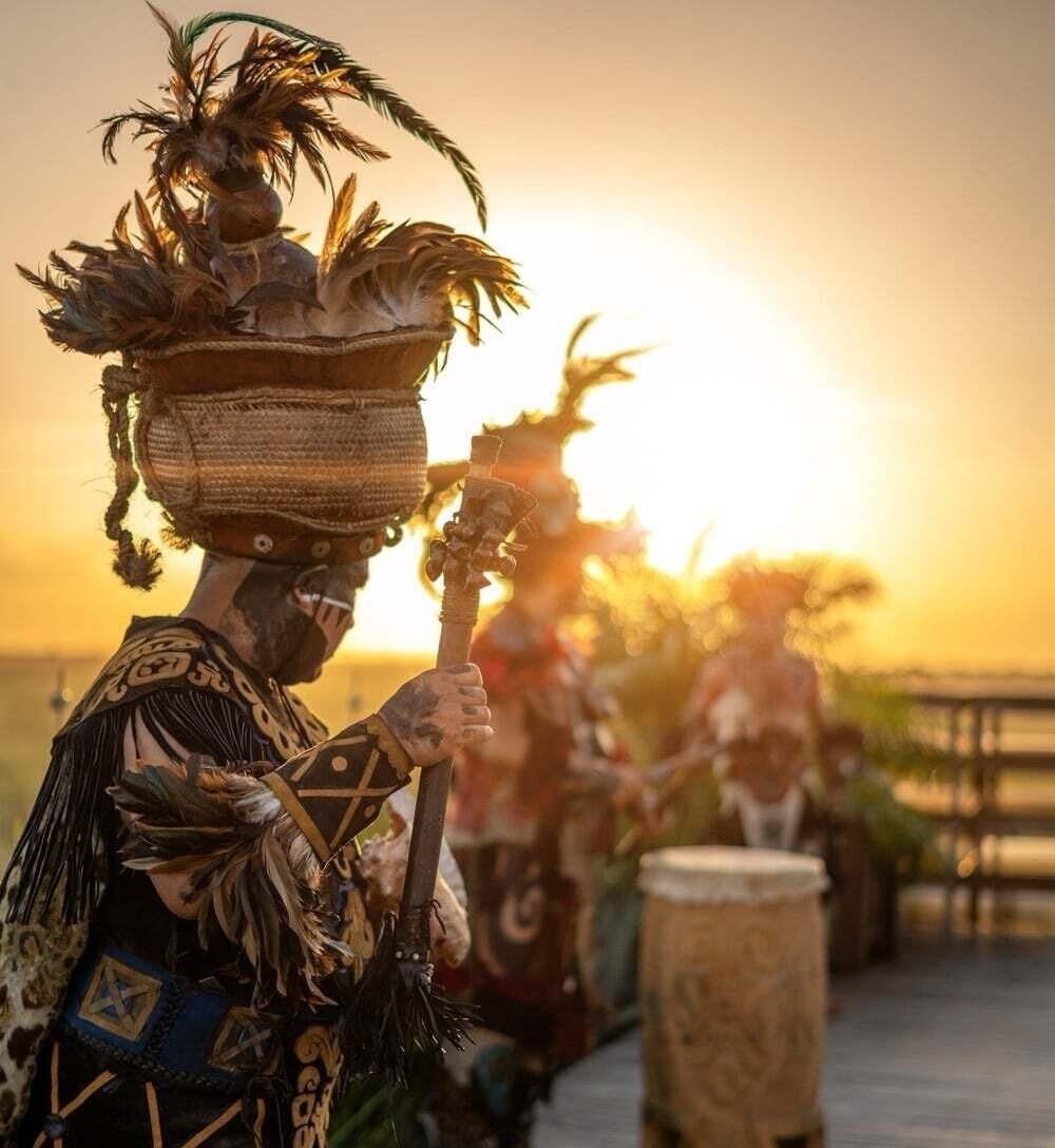 an aerial view of a sandy beach with blue water