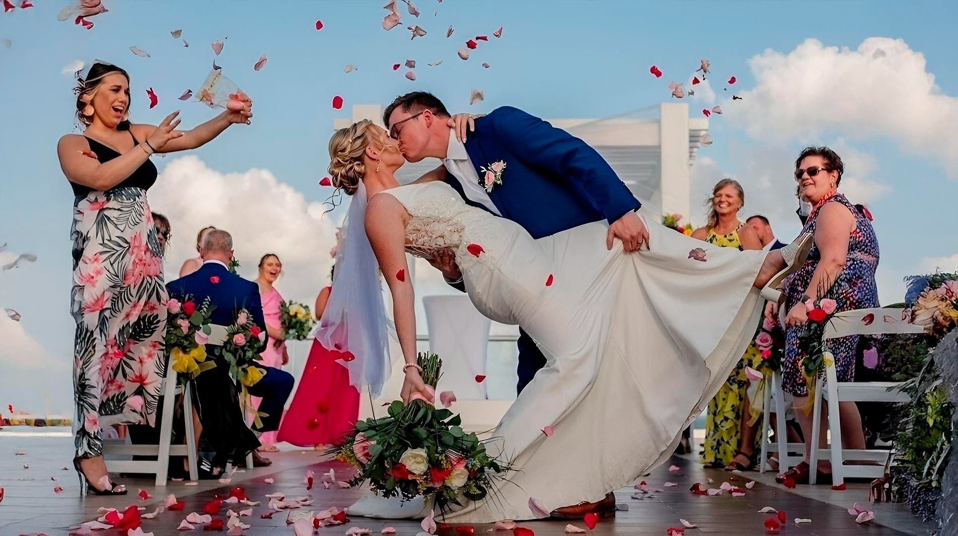 a bride and groom kiss under a wooden arch