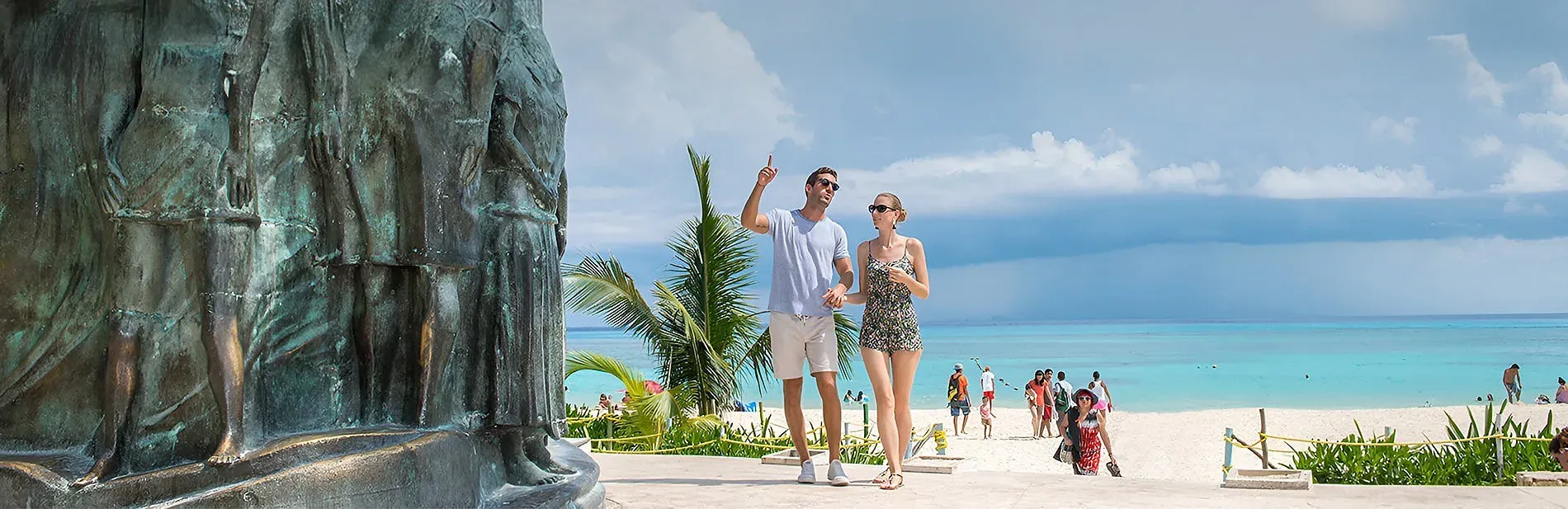Couple strolls by beach sculpture in Playa del Carmen | The Fives Hotels | Riviera Maya