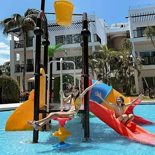 Kids enjoy water slide & bucket at The Fives Corpo resort.