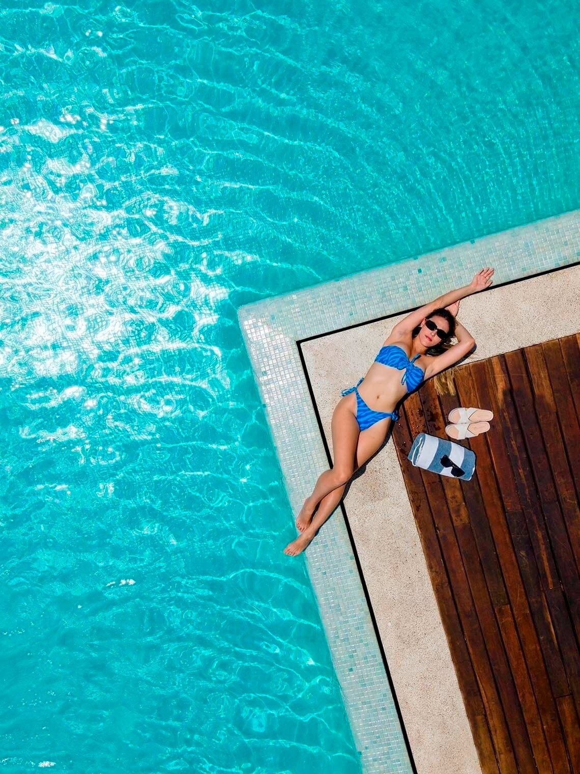 Relax poolside at The Fives Downtown Hotel, a Curio Collection by Hilton.