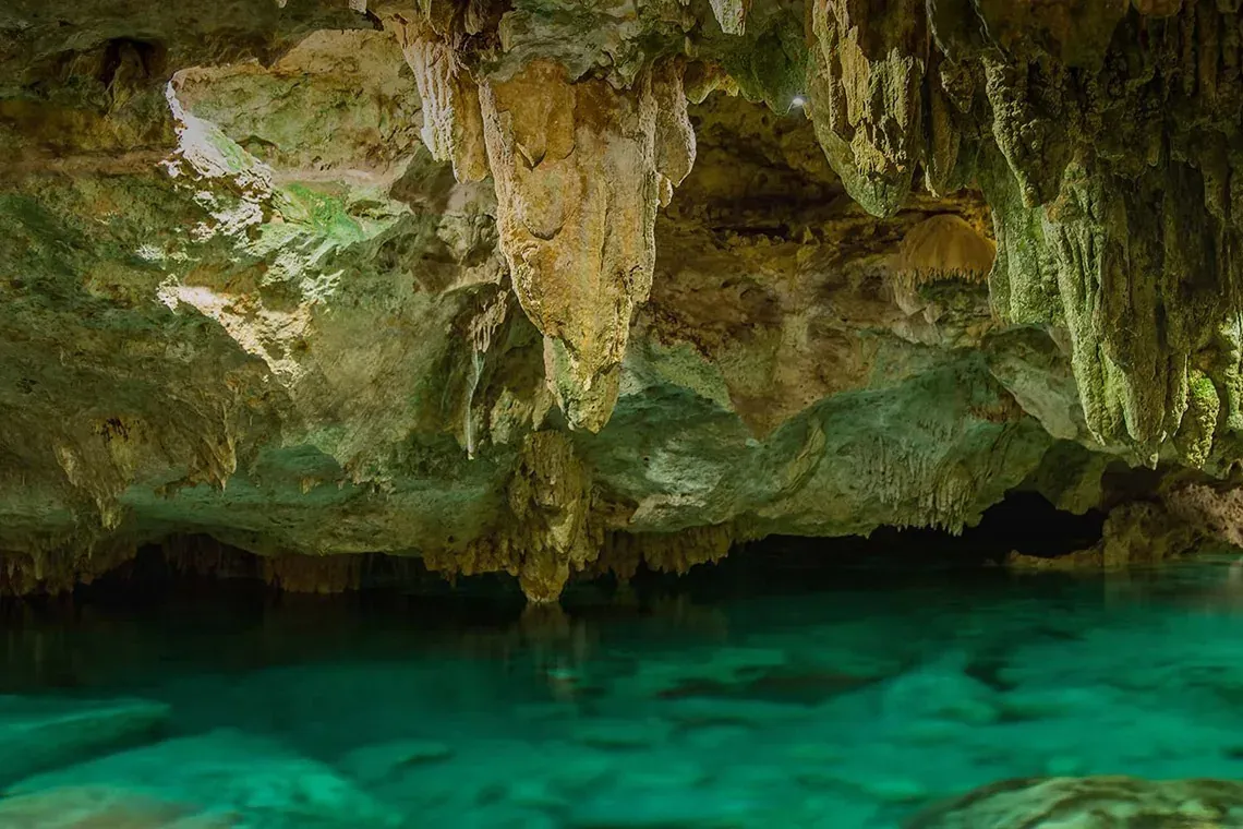 Crystal clear waters at The Fives Corpo. Marvel at cave formations.