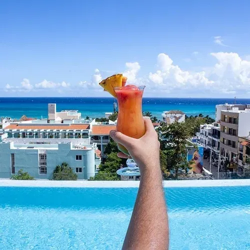 Sip a tropical cocktail at The Fives Corpo, overlooking the Caribbean Sea and pool.