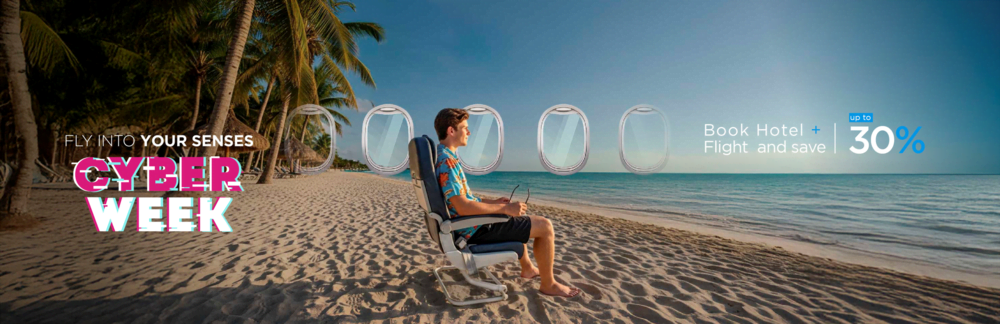 a man and woman standing on a balcony overlooking a swimming pool