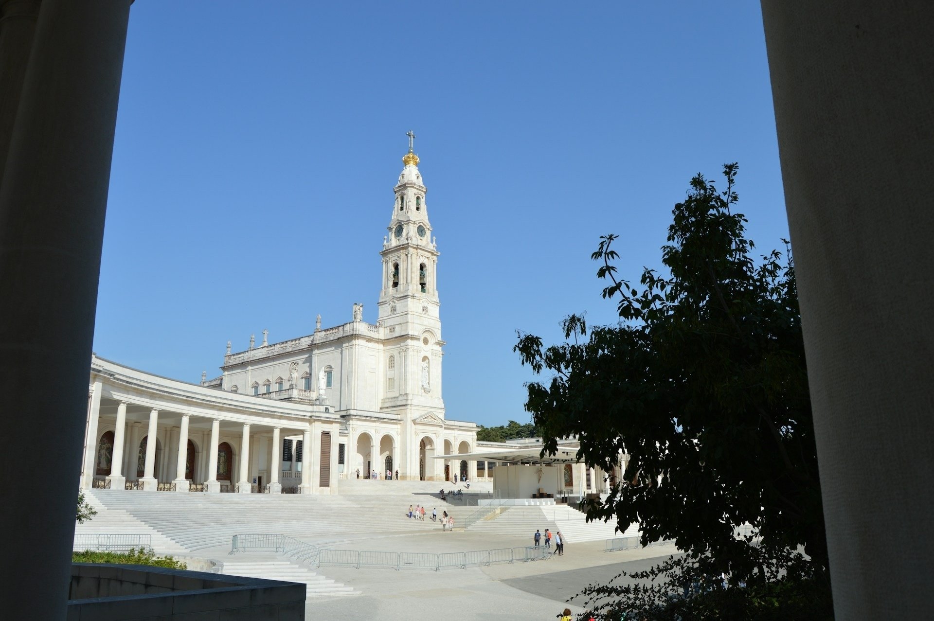 a row of white buildings with a blue sky in the background