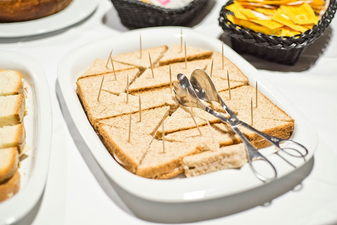 Triangle sandwiches and skewers on a white plate, Golden Tulip Sao Joao da Madeira | Official website.