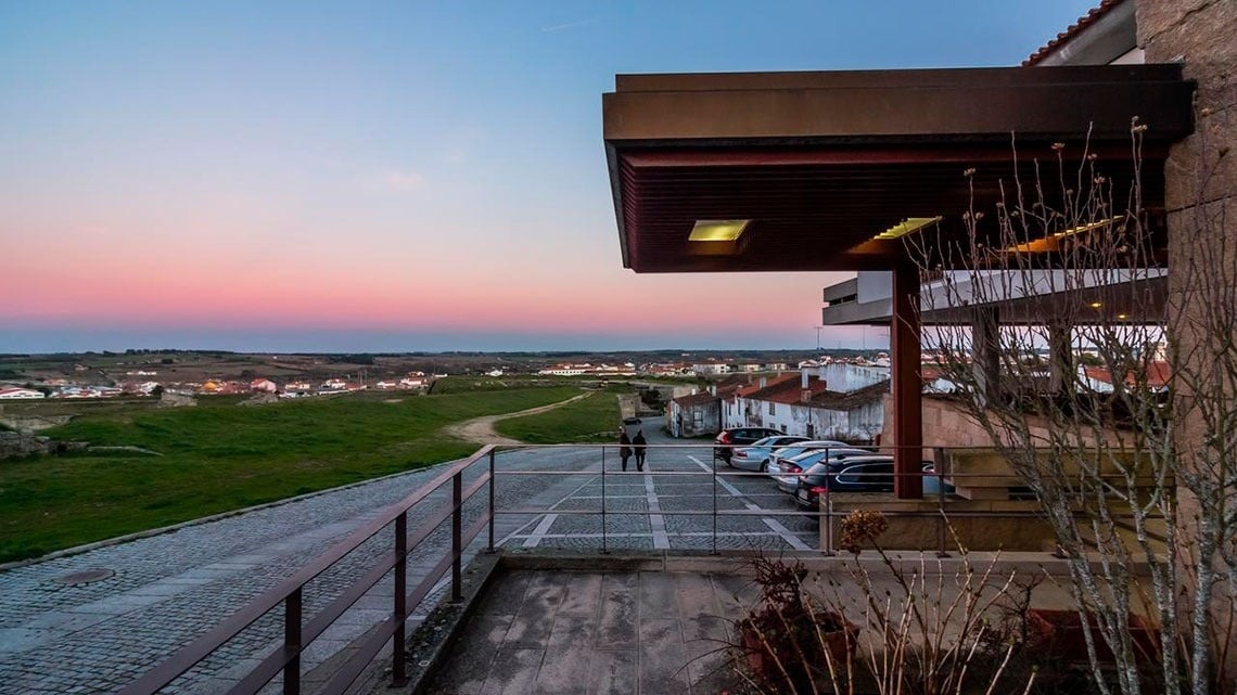 a view of a parking lot with a sunset in the background