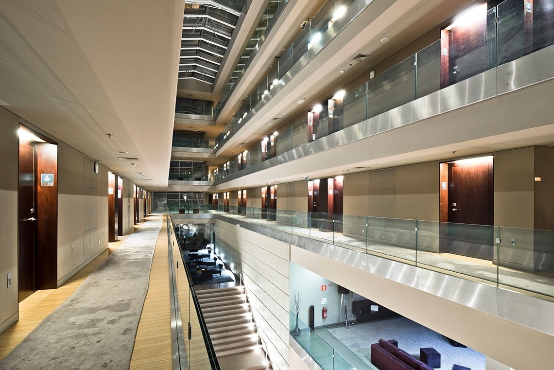 Modern hotel atrium with balconies and elevators. Golden Tulip Sao Joao da Madeira | Official website.