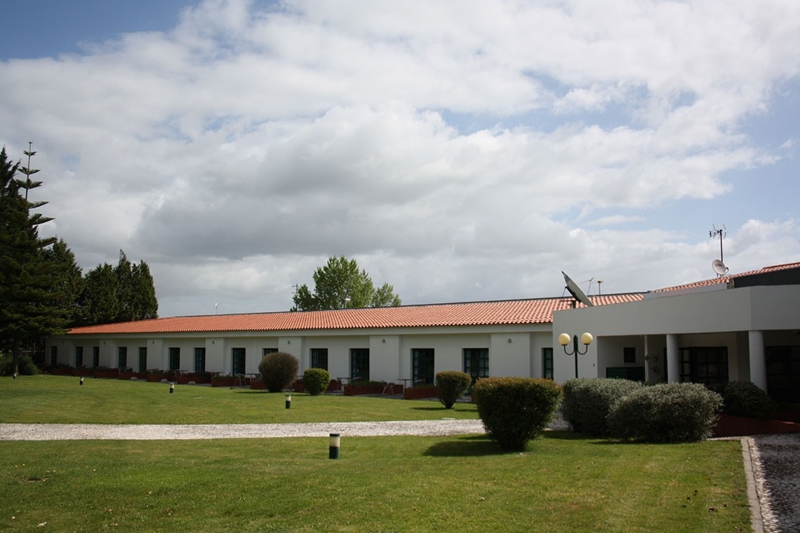 a large white building with a red tile roof