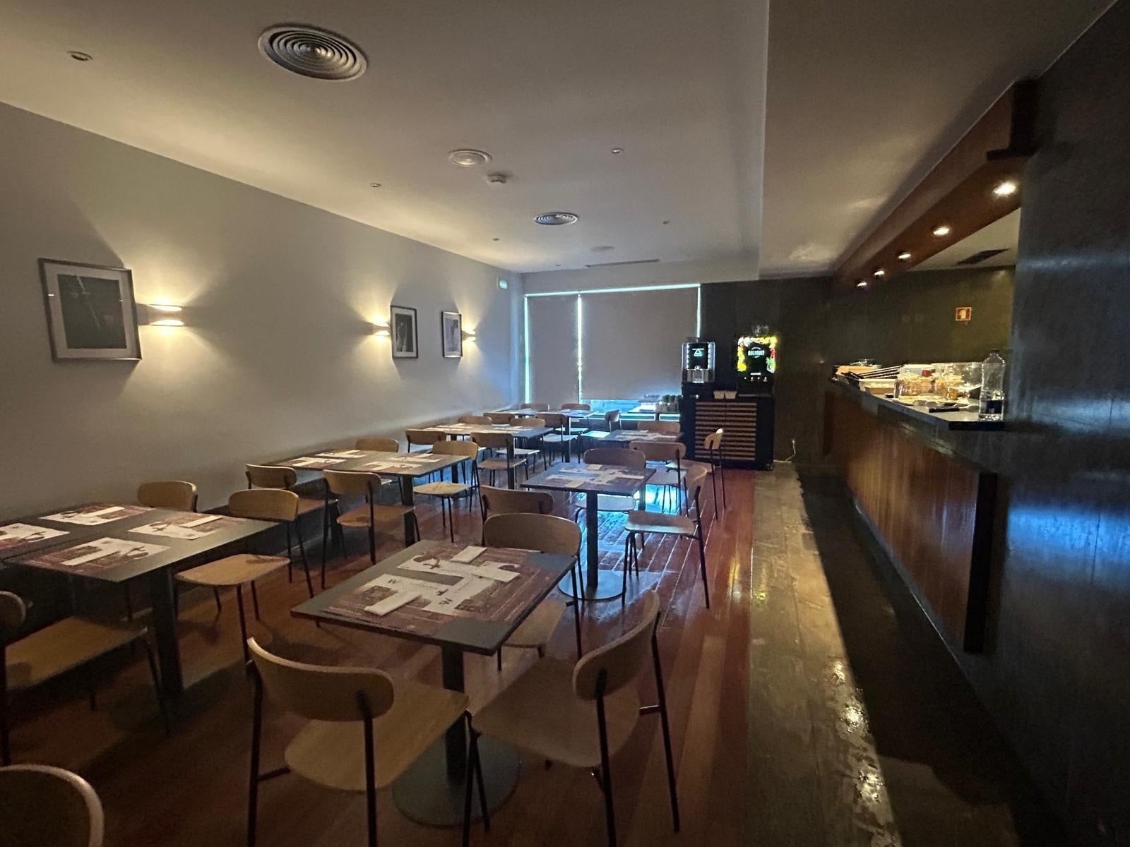 a lake surrounded by mountains with a road going through it