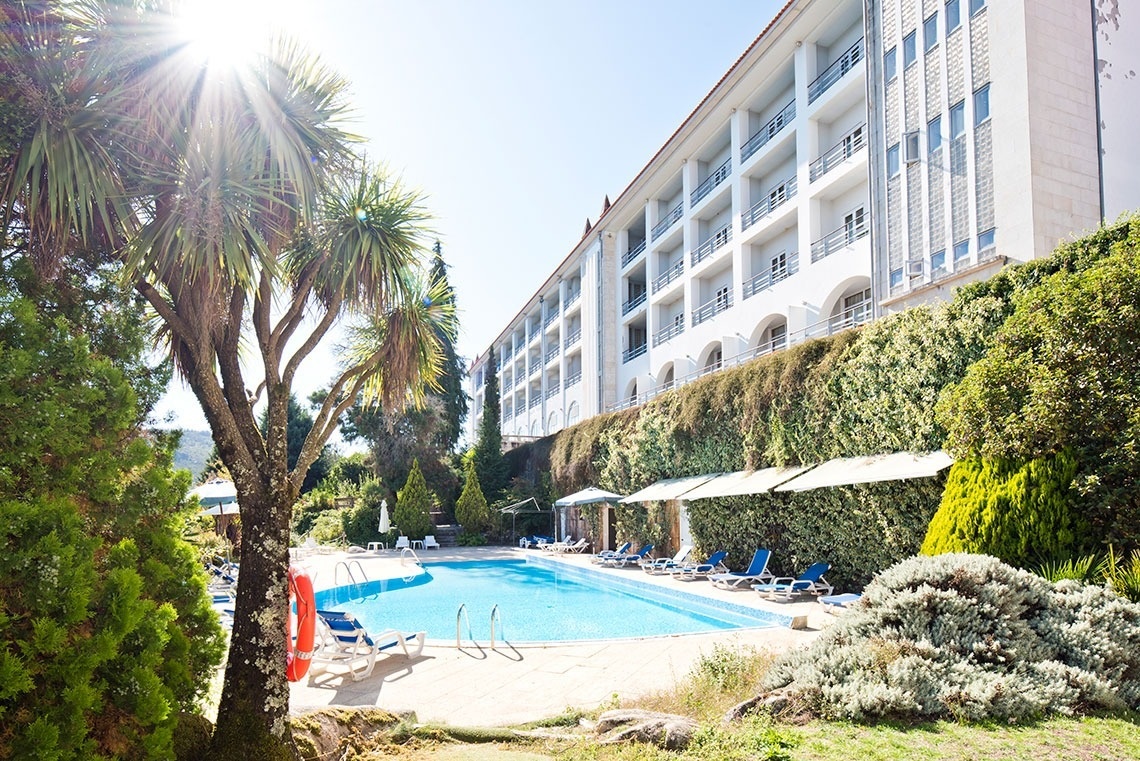 a large building with a swimming pool in front of it