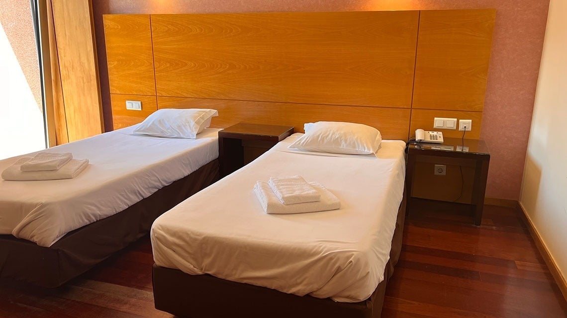 Two beds in a room at Flag Hotel Barcelos. Book your stay on our official website!