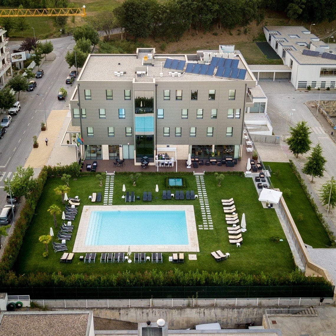 Aerial view of Lam Hotel Celorico de Basto with pool, lawn, and sun loungers.