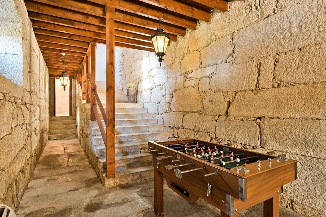 Sala de juegos con futbolín y piedra rústica en Lam Hotel Convento do Desagravo | Web oficial.