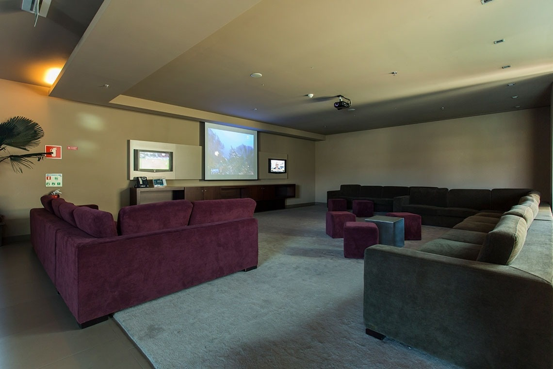 Cinema room with plush sofas at Golden Tulip Sao Joao da Madeira. Official website.