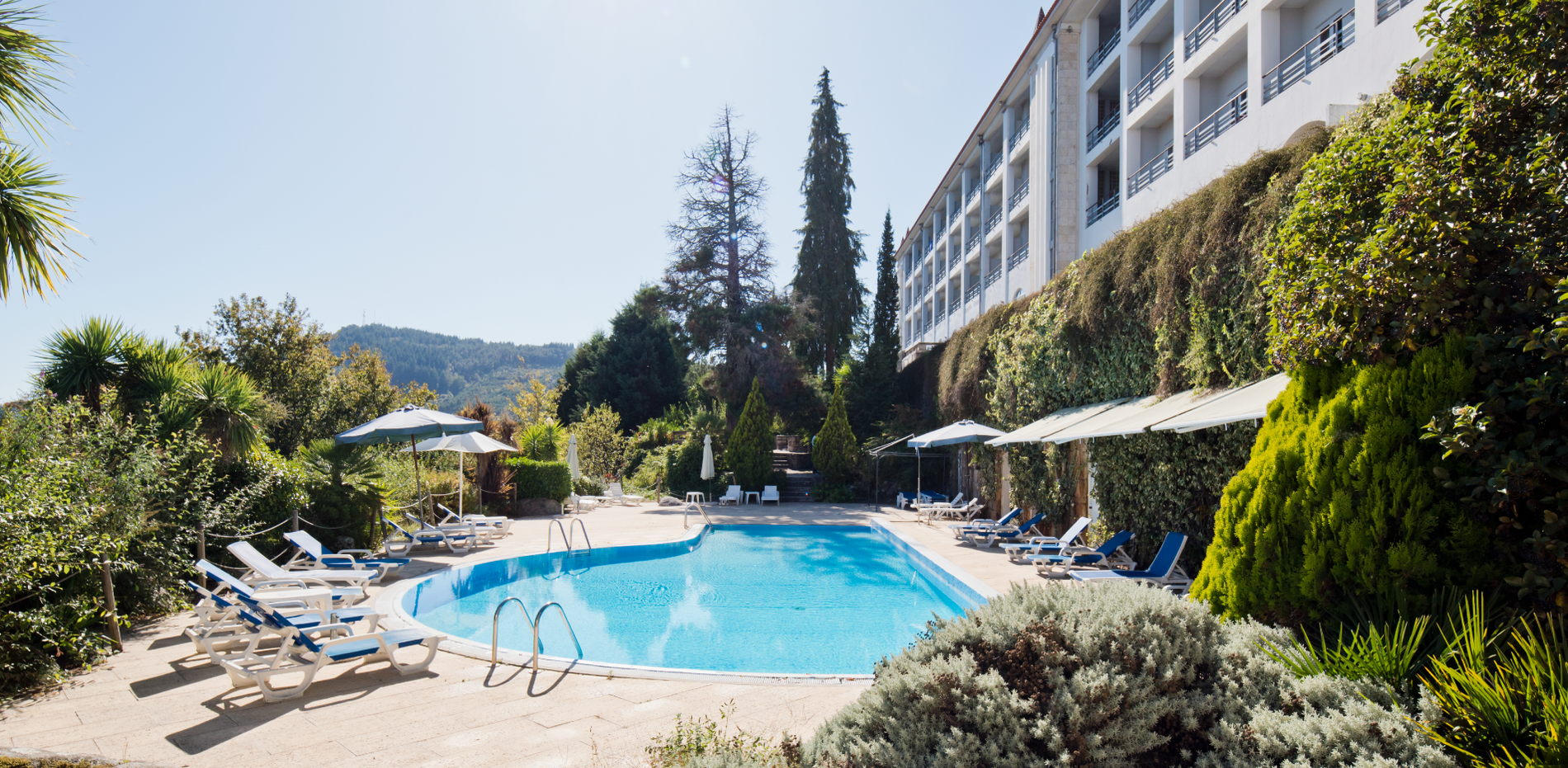 a large building with a swimming pool in front of it