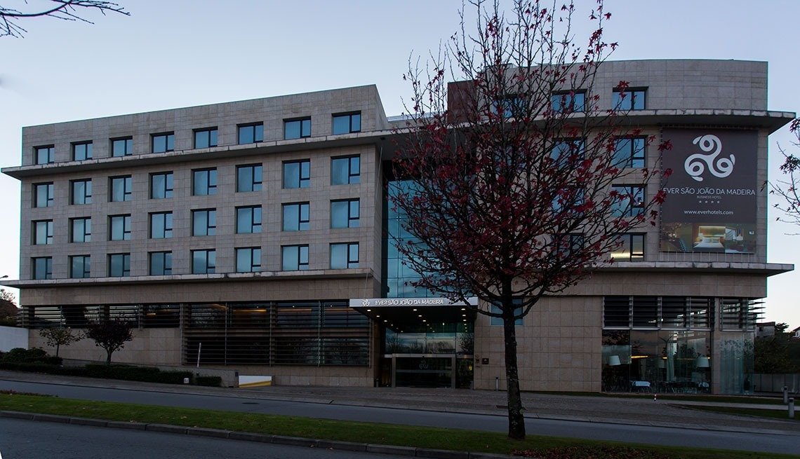 Modern hotel exterior of Golden Tulip Sao Joao da Madeira, with elegant architecture and a prominent sign.