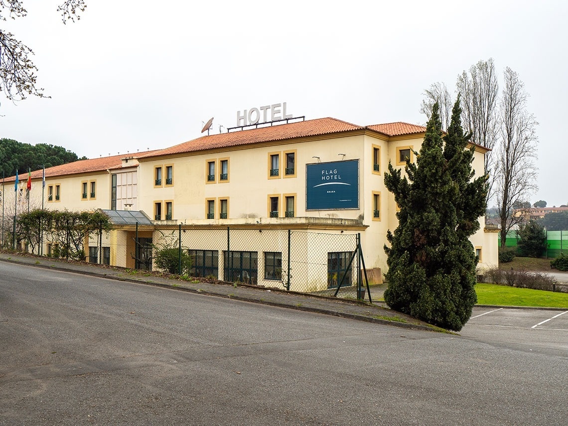 a hotel with a blue sign that says flag hotel