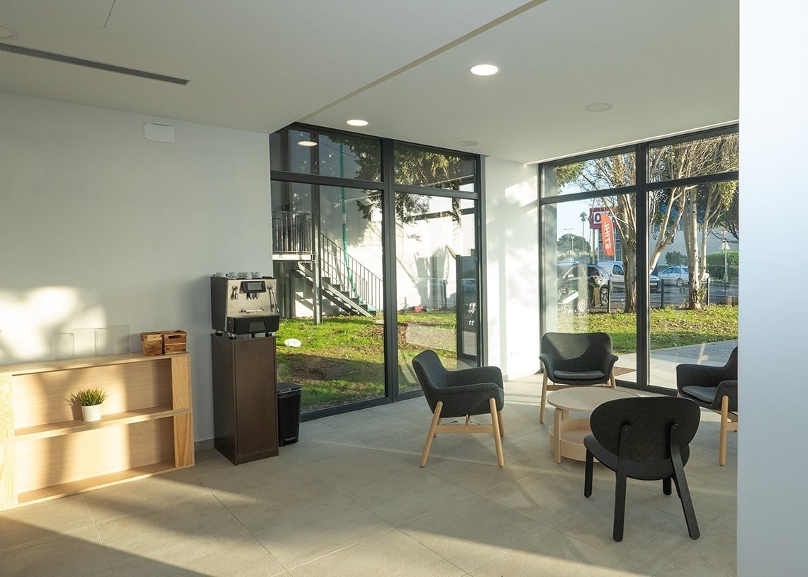 Modern lobby lounge with coffee station and outdoor views. Flag Hotel Lisbon Sintra | Official website.
