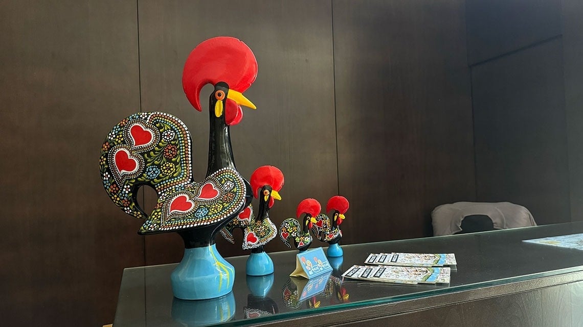 Colorful Barcelos roosters at Flag Hotel Barcelos reception desk.