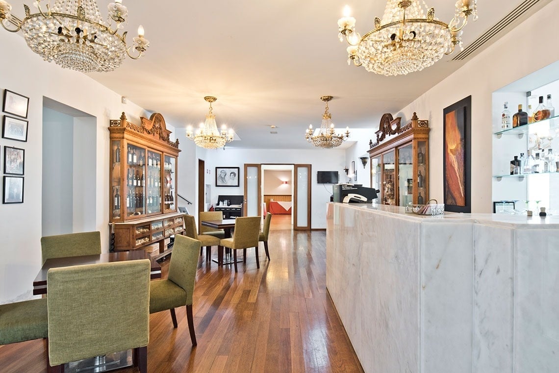 a dining room with tables and chairs and a bar