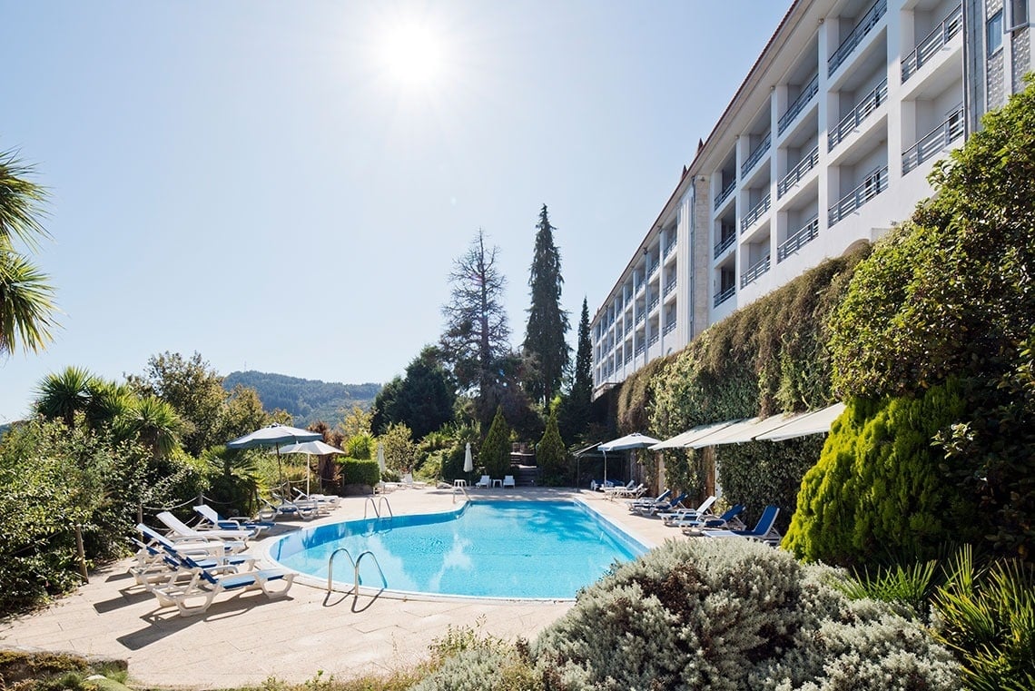 a large building with a swimming pool in front of it