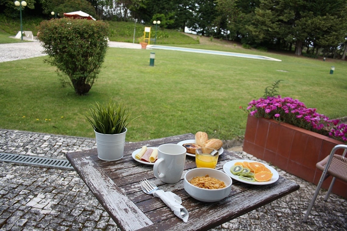 Enjoy a delicious breakfast at Flag Hotel Santarém, featuring fresh fruit, pastries, and cereal by the pool.