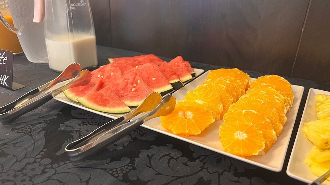 Fresh fruit buffet at Flag Hotel Barcelos: watermelon, oranges, and pineapple. Book your stay!