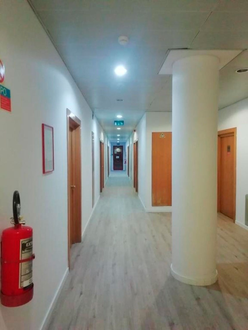 Corredor do Flag Hotel Porto-Maia com extintor e coluna grande. Visite o site oficial.