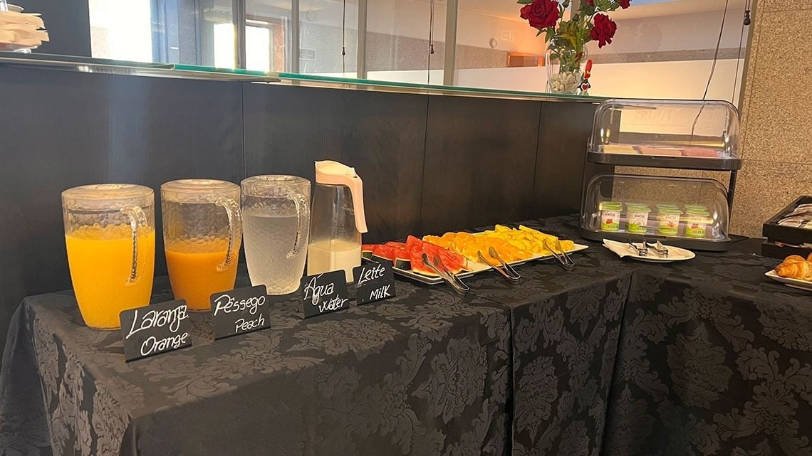 Breakfast buffet at Flag Hotel Barcelos: juices, fruits, milk, yogurt & pastries.