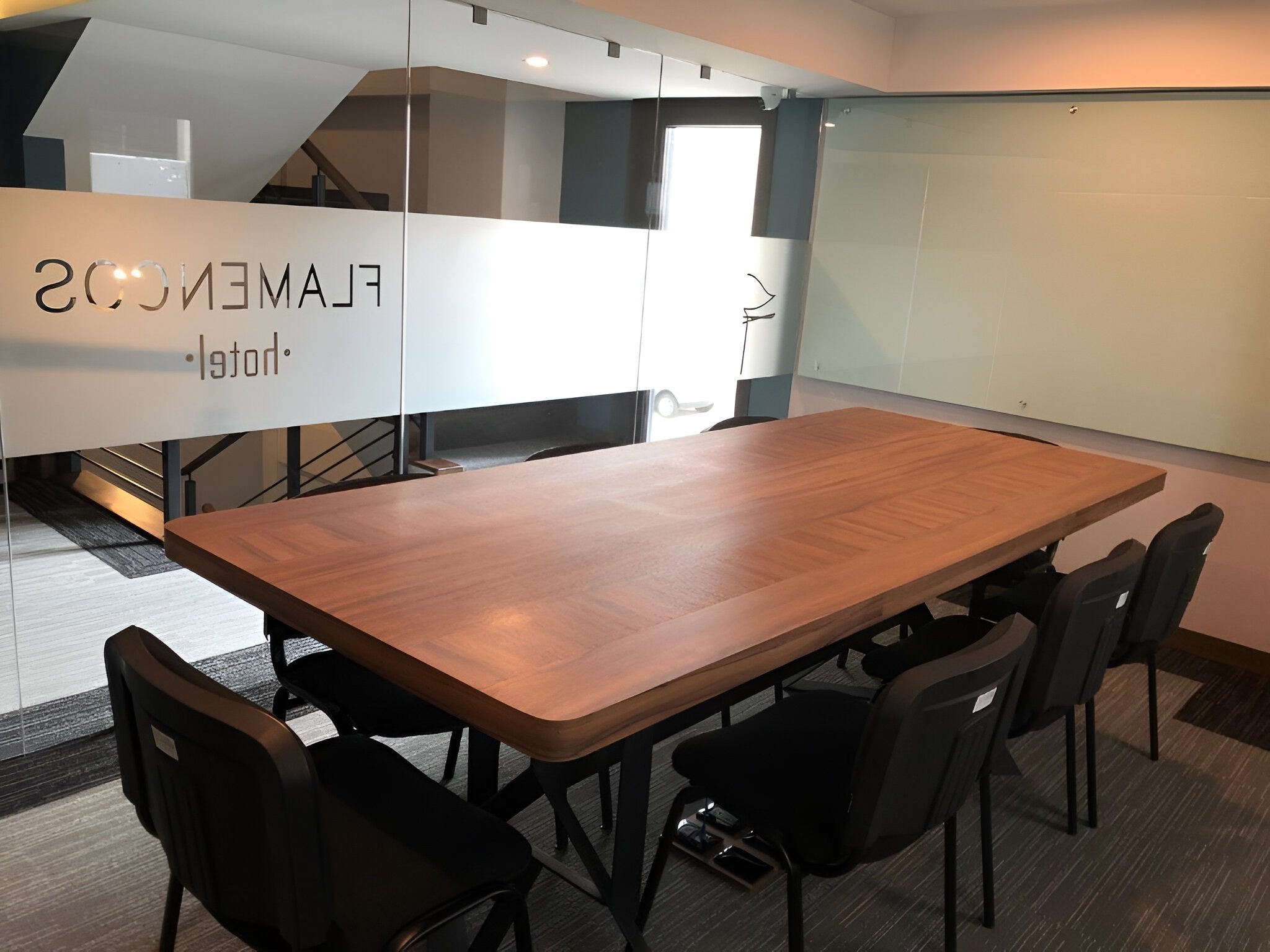 a conference room with a wooden table and chairs