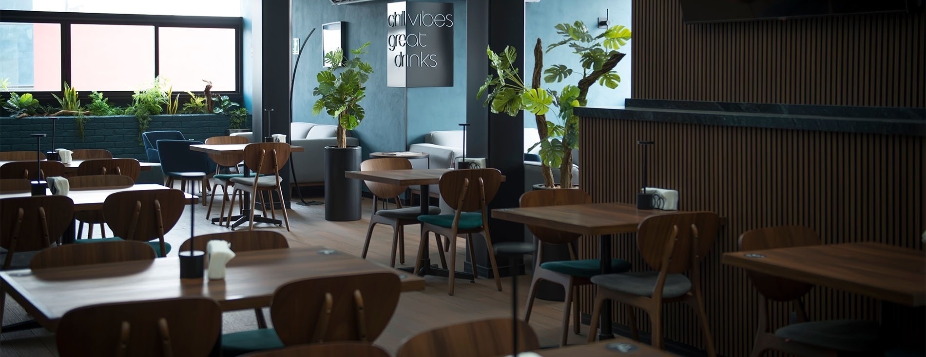 a restaurant with tables and chairs and a sign that says services great drinks
