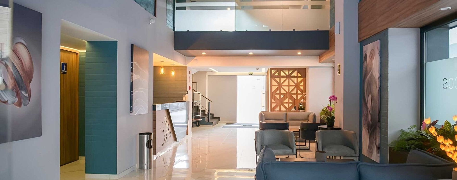 a waiting room with a couch and chairs and a sign that says " welcome "